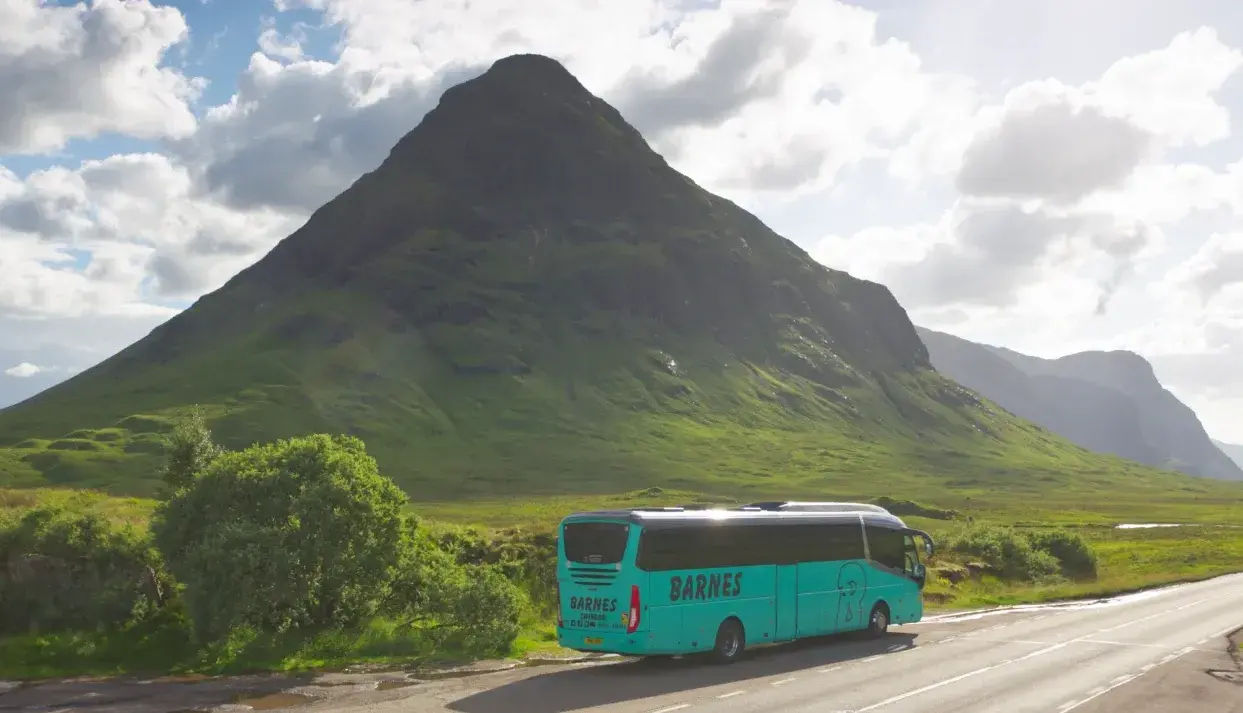 Barnes coach driving through mountain range